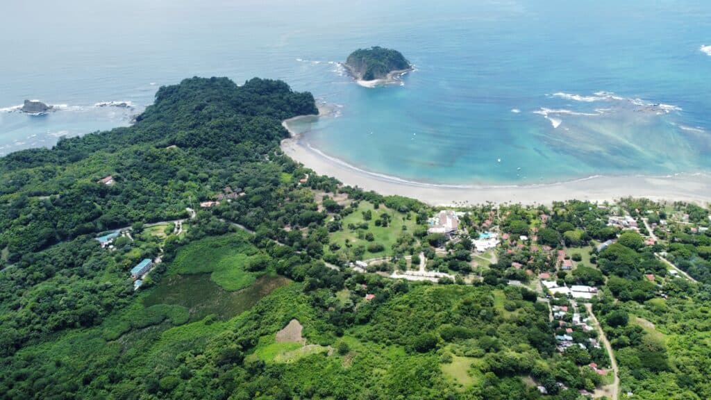 Aerial drone photo of Sámara bay in Guanacaste, Costa Rica, with Isla Chora in the background